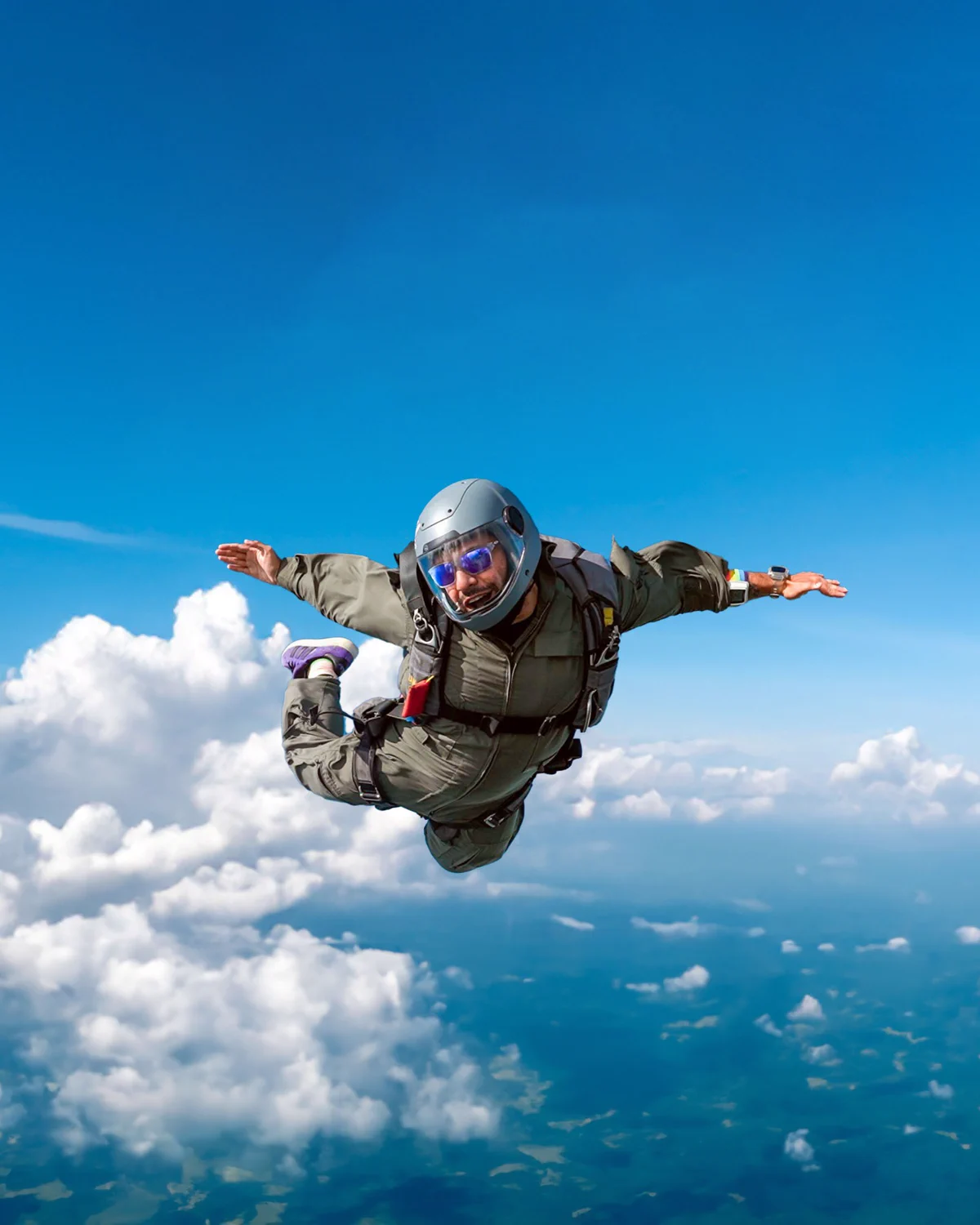 Aakash Malhotra skydiving above the clouds